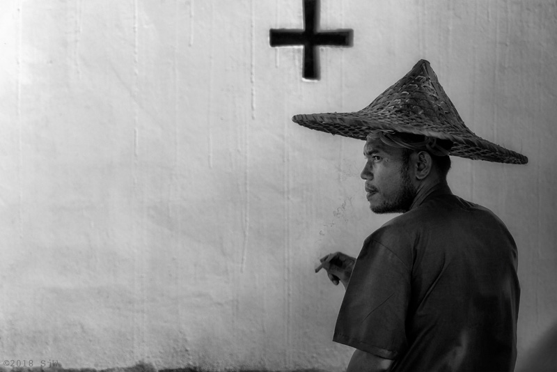 Rickshaw driver smoking in the shade
