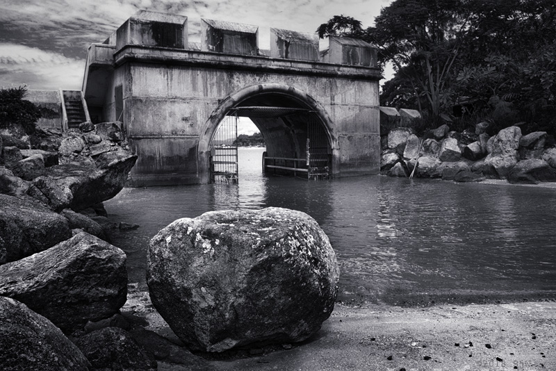 Sea wall and rocks with a calm sea